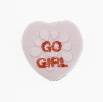 Royalty Free Photo of a Purple Candy Heart That Reads Go Girl Against a White Background