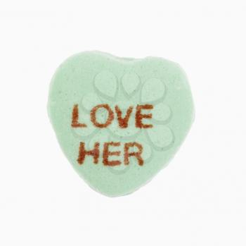 Royalty Free Photo of a Green candy heart that reads love her against white background