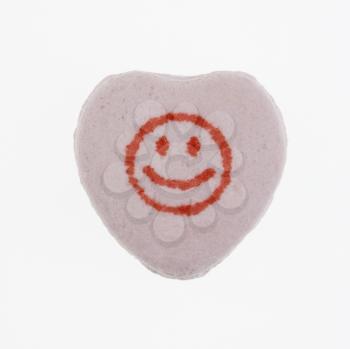 Royalty Free Photo of a Purple Candy Heart With a Smiley Face