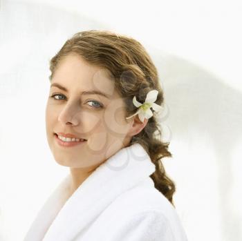 Royalty Free Photo of a Woman Wearing a Robe With an Orchid in Her Hair