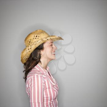 Royalty Free Photo of a Profile of a Young Woman Wearing a Cowboy Hat Smiling