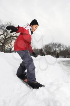 Royalty Free Photo of a Boy Snowboarding in Snow