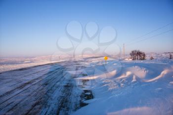 Royalty Free Photo of an Ice Covered Road and Snowy Rural Landscape