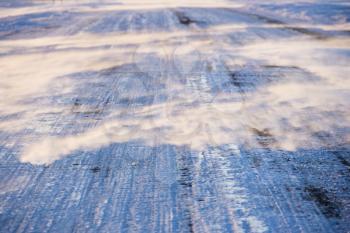 Royalty Free Photo of a Close-Up of Ice Covered Road with Tire Marks