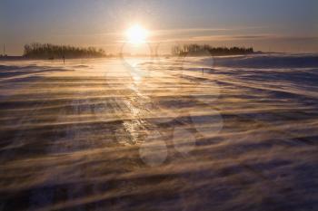 Royalty Free Photo of an Ice Covered Road With Sun Rising in the Distance