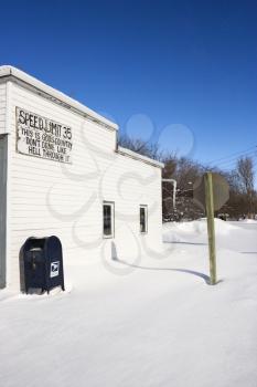 Royalty Free Photo of a Small Town Street Scene With Building and Postal Mailbox