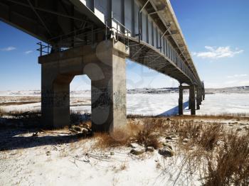 Royalty Free Photo of a Woman a Bridge Over Frozen Water in Midwestern, USA