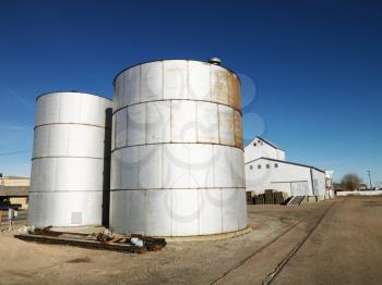Royalty Free Photo of Two Silos in a Rural Setting