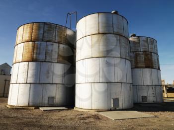 Royalty Free Photo of Three Silos in a Rural Setting