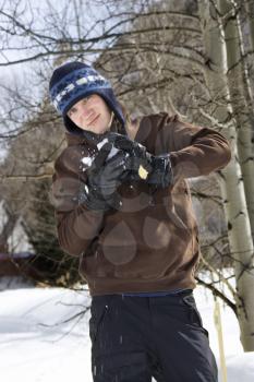 Royalty Free Photo of a Teenager Making a Snowball
