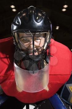 Royalty Free Photo of a Female Hockey Goalie Wearing a Helmet, Sneering and Looking Intimidating