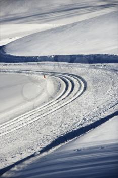 Royalty Free Photo of Snowmobile Tracks Winding Through Winter Snow