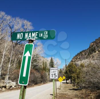 Royalty Free Photo of Several Street Signs along side a Road in Utah, USA