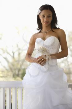 Royalty Free Photo of an African American Bride Leaning Against a Railing