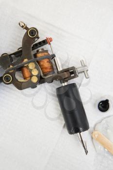 Royalty Free Photo of a Tattoo Gun and Black Ink
