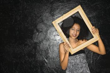 Royalty Free Photo of a Woman Holding a Frame Over Her Face