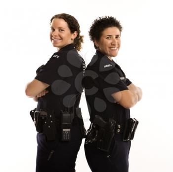 Royalty Free Photo of Policewomen Standing Back to Back With Their Arms Crossed and Smiling