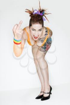 Royalty Free Photo of a Woman With Tattoos Making an Obscene Gesture
