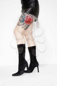 Royalty Free Photo of a Tattooed Female in a Leather Dress