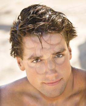 Royalty Free Photo of a Head and Shoulder Portrait of a Handsome Man on a Beach