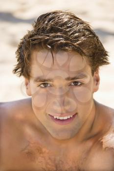 Royalty Free Photo of a Head and Shoulder Portrait of a Handsome Man on a Beach