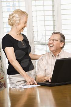 Royalty Free Photo of a Mature Caucasian couple looking at laptop