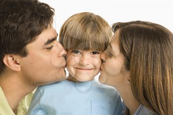 Royalty Free Photo of a Mother and Father Kissing Their Son on the Cheeks