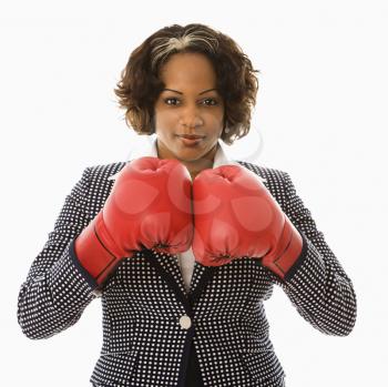 Businesswoman wearing boxing gloves.