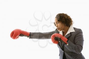 Royalty Free Photo of a Businesswoman Wearing Boxing Gloves Punching