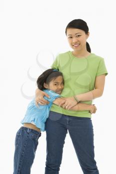 Royalty Free Photo of a Mother and Daughter Standing and Hugging