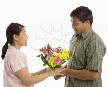 Royalty Free Photo of a Man Giving a Woman Flowers