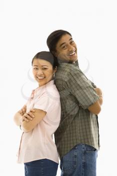 Royalty Free Photo of a Man and Woman Standing Back to Back Smiling