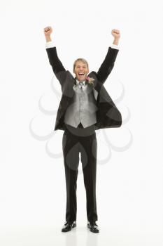 Royalty Free Photo of a Groom With Arms Raised in the Air