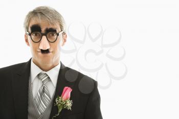 Royalty Free Photo of a Groom Wearing Groucho Glasses