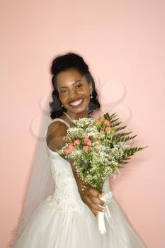 Royalty Free Photo of a Bride Holding Out a Bouquet