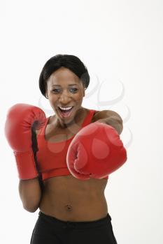 Royalty Free Photo of a Woman Wearing Boxing Gloves Throwing Playful Punches