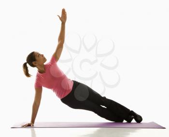 Royalty Free Photo of a Woman Holding a Yoga Pose and Stretching