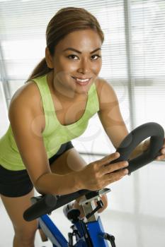 Royalty Free Photo of a Woman Pedaling on an Exercise Bike