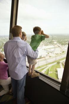 Royalty Free Photo of a Family Looking Out the Observation Deck at the Tower of the Americas in San Antonio, Texas
