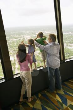 Royalty Free Photo of a Family Looking Out an Observation Deck at Tower of the Americas in San Antonio, Texas