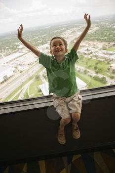 Royalty Free Photo of a Boy Sitting on an Observation Deck at Tower of the Americas in San Antonio, Texas