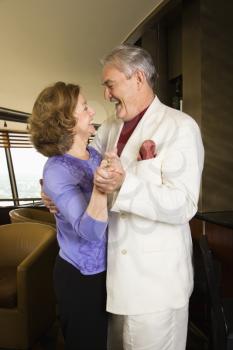 Royalty Free Photo of an Older Couple Dancing and Laughing