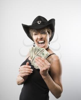 Royalty Free Photo of a Woman Making a Facial Expression and Holding Twenty Dollar Bills