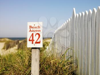 Royalty Free Photo of a Beach Access Sign With a Picket Fence at Bald Head Island, North Carolina
