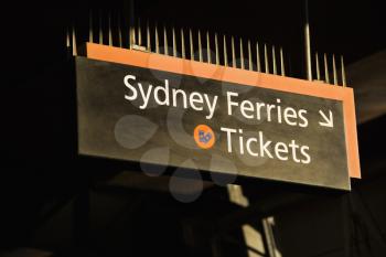 Royalty Free Photo of a Sign Pointing to a Ticket Booth for Ferryboats in Sydney, Australia