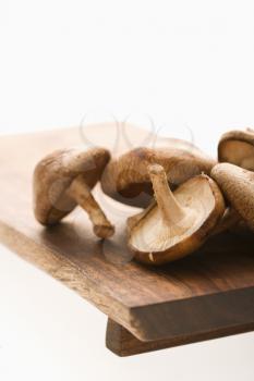 Royalty Free Photo of Shiitake Mushrooms on a Cutting Board