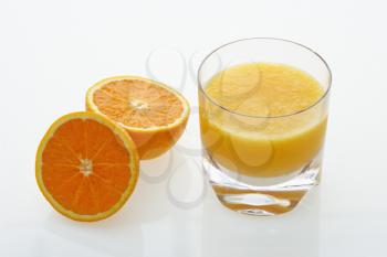 Royalty Free Photo of a Halved Orange and Glass of Orange Juice