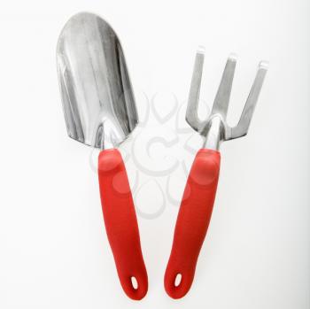 Royalty Free Photo of a Hand Held Spade and Gardening Fork