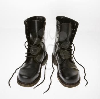 Black leather boots with laces untied.
