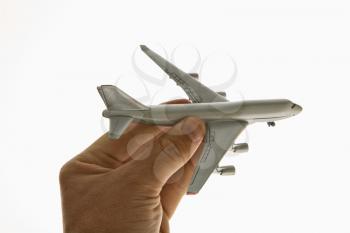 Royalty Free Photo of a Hand Holding a Toy Airplane